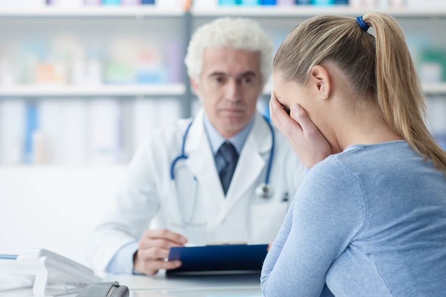 Woman Receiving Bad News From Her Doctor