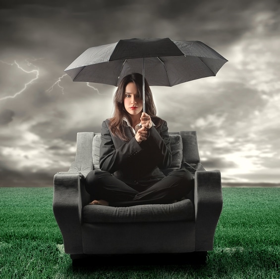 business woman on an armchair lost in countryside during a storm