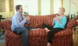 Nick Ortner and Louise Hay sitting on a couch